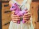 child holding unicorn toy