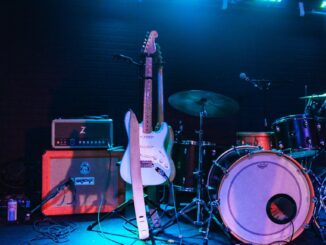 photo of electric guitar and drum set