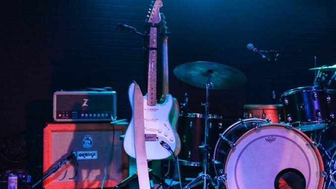 photo of electric guitar and drum set