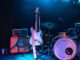 photo of electric guitar and drum set