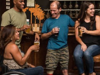 people on the bar drinking and conversing
