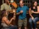 people on the bar drinking and conversing